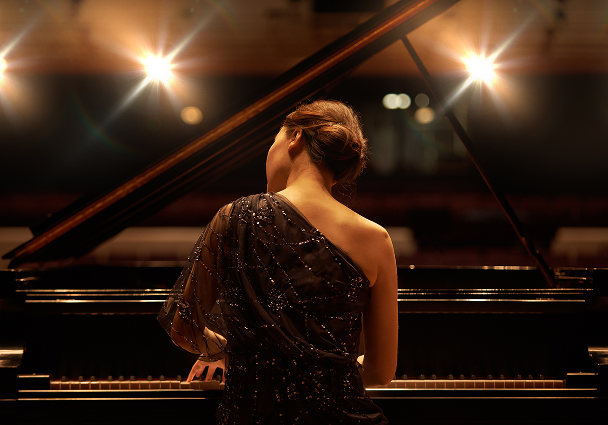 Piano Class Performing for the audience. Shot of a young woman playing the piano during a musical concert